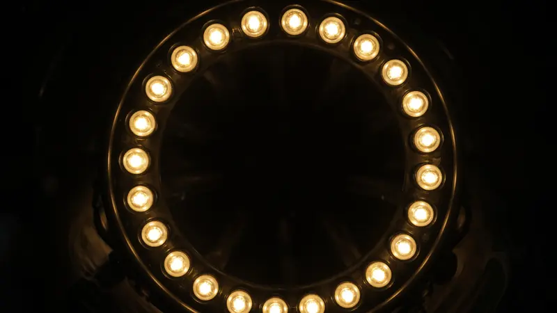 Warm bulbs around a disc on the LakhBet Dream Catcher still.
