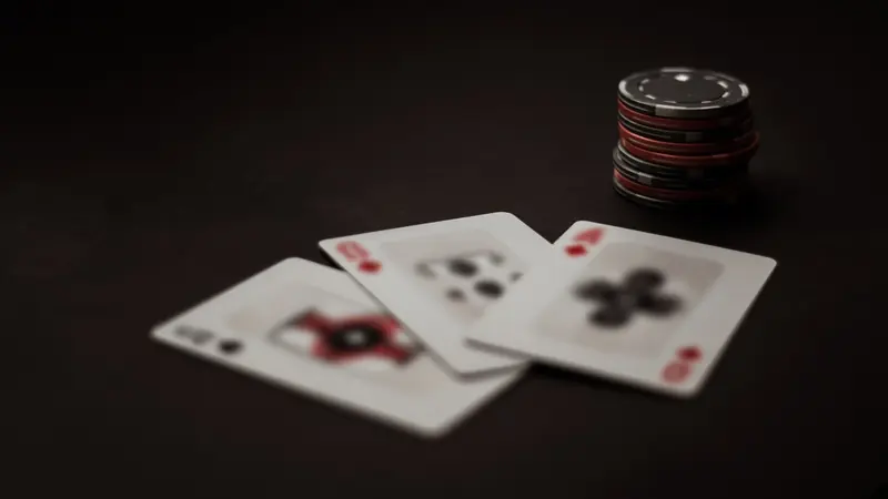 Three face-up cards lie on a green LakhBet Teen Patti table.